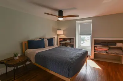 a bedroom with a bed and a ceiling fan at BurgBnB Downtown in Harrisburg