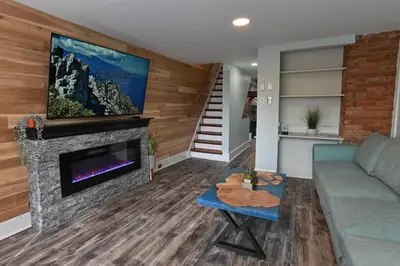 a living room with a couch and a fireplace at BurgBnB Downtown in Harrisburg