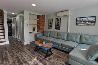 a living room with a couch and a table at BurgBnB Downtown in Harrisburg