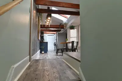 a hallway with a table and chairs in a room at BurgBnB Downtown in Harrisburg