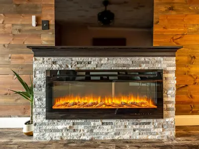 a fireplace in a living room with flames at BurgBnB Downtown in Harrisburg