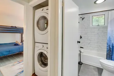 a bathroom with a washer and dryer in a house at Community Pools and Hot Tub Albrightsville Cottage! in Albrightsville