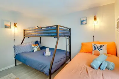 a bedroom with two beds and a bunk bed at Community Pools and Hot Tub Albrightsville Cottage! in Albrightsville