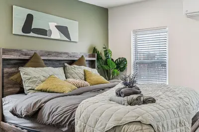 a bedroom with a large bed with a dog laying on it at Luxurious couples suite KING BED, romantic, central, wifi in Philadelphia