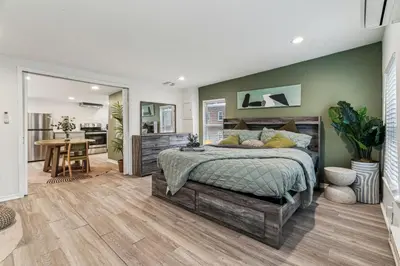 a bedroom with a bed and a dining room at Luxurious couples suite KING BED, romantic, central, wifi in Philadelphia