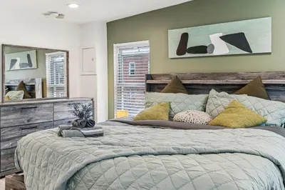 a bedroom with a large bed and a mirror at Luxurious couples suite KING BED, romantic, central, wifi in Philadelphia