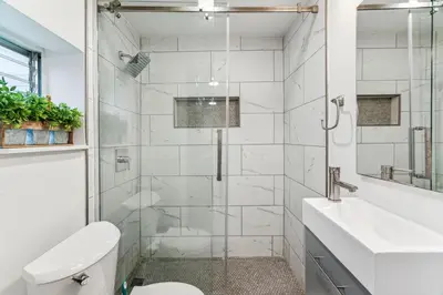 a bathroom with a shower and a toilet and a sink at Luxurious couples suite KING BED, romantic, central, wifi in Philadelphia