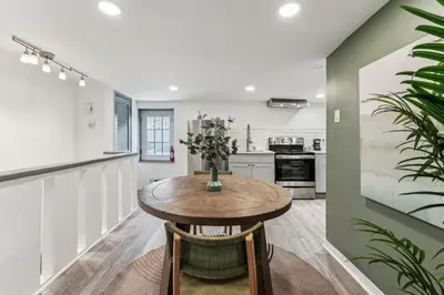 a kitchen with a wooden table and chairs at Luxurious couples suite KING BED, romantic, central, wifi in Philadelphia