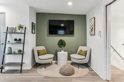 a living room with two chairs and a tv at Luxurious couples suite KING BED, romantic, central, wifi in Philadelphia