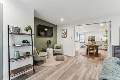 a living room with a couch and a table at Luxurious couples suite KING BED, romantic, central, wifi in Philadelphia