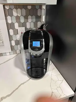 a cell phone is sitting on top of a counter at Newly Renovated 2 BR downtown Apt, family getaway. in Montclair