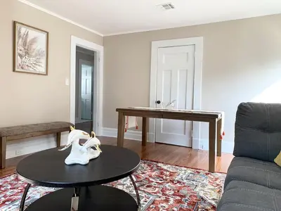 a living room with a table and a couch at Newly Renovated 2 BR downtown Apt, family getaway. in Montclair