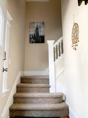 a staircase in a home with a picture on the wall at Lovely 1 BD downtown 2F apt in quite neighborhood in Montclair