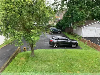 a car parked in a parking lot in a yard at Lovely 1 BD downtown 2F apt in quite neighborhood in Montclair