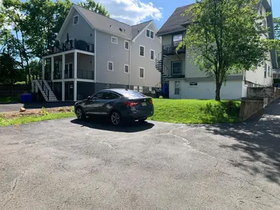 a car parked in a driveway in front of a house at Lovely 1 BD downtown 2F apt in quite neighborhood in Montclair