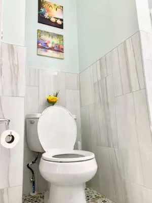 a white bathroom with a toilet and a sink at Lovely 1 BD downtown 2F apt in quite neighborhood in Montclair