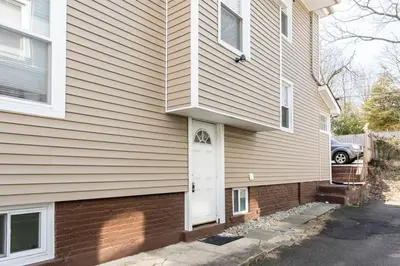 a house with a white door on the side of it at Semi Private cozy studio near downtown. in Montclair