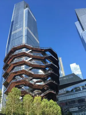 a tall glass building in front of some buildings at Double Room in New York