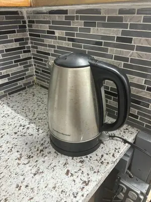a kettle sitting on a table next to a brick wall at Double Room in New York