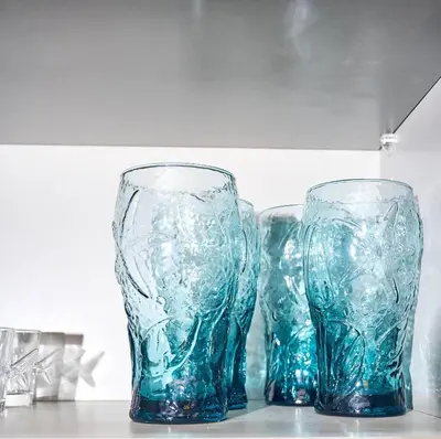 three blue glass vases sitting on top of a counter at Siren's Cozy Cove Hideaway Mins from Downtown in Philadelphia