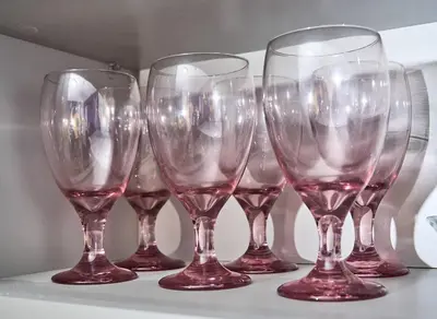 a row of wine glasses sitting on a shelf at Siren's Cozy Cove Hideaway Mins from Downtown in Philadelphia