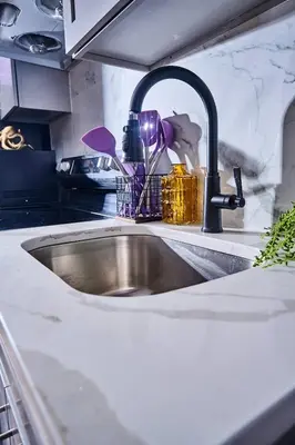 a kitchen sink with a faucet in a kitchen at Siren's Cozy Cove Hideaway Mins from Downtown in Philadelphia