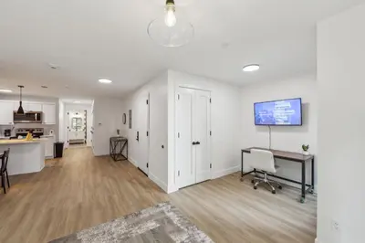 an open living room with a desk and a kitchen at Beautiful New Apartment I 1 Bedroom 1 Bathroom in Wilmington