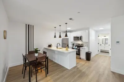 a kitchen and living room with a table and chairs at Beautiful New Apartment I 1 Bedroom 1 Bathroom in Wilmington