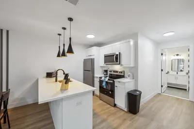 a kitchen with white cabinets and a white counter top at Beautiful New Apartment I 1 Bedroom 1 Bathroom in Wilmington