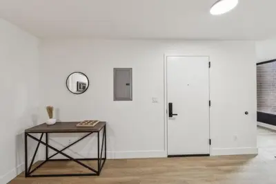 a room with a table and a white wall at Beautiful New Apartment I 1 Bedroom 1 Bathroom in Wilmington