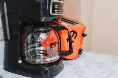 a black and orange blender sitting on a counter at NYC 2 Bed America Dream Mall Train Station in Newark