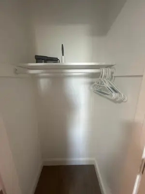 a white room with a shelf on the wall at Cozy 2-3 Bedroom Apartment in Center City! in Philadelphia