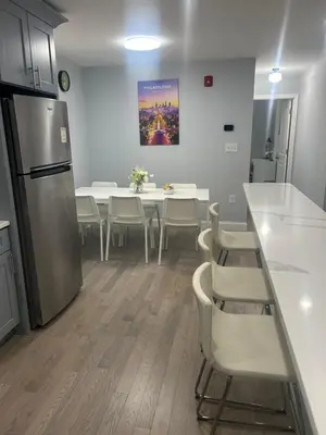 a kitchen and dining room with a table and chairs at Cozy 2-3 Bedroom Apartment in Center City! in Philadelphia
