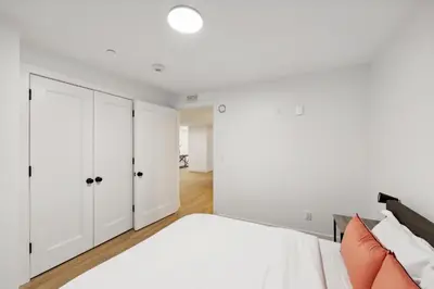 a white bedroom with a bed and white cabinets at Market View Residence 503 I 1 Bedroom 15 Bathroo in Wilmington