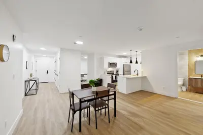 a living room with a table and chairs and a kitchen at Market View Residence 503 I 1 Bedroom 15 Bathroo in Wilmington