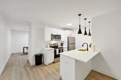 a kitchen with white cabinets and a white counter top at Market View Residence 503 I 1 Bedroom 15 Bathroo in Wilmington