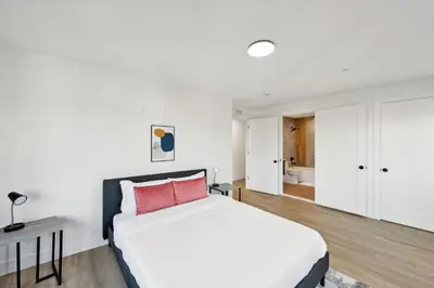 a bedroom with a large white bed with a red pillow at Market View Residence 504 I 2 Bedroom 2 Bathroom in Wilmington