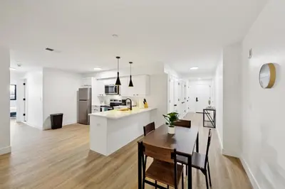 a white kitchen and dining room with a table and chairs at Market View Residence 504 I 2 Bedroom 2 Bathroom in Wilmington