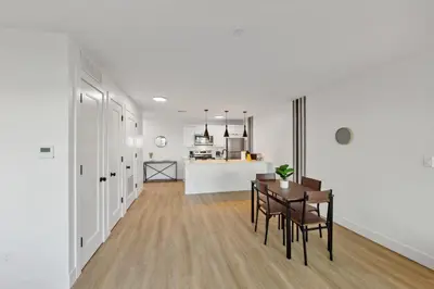 a living room and kitchen with a table and chairs at Market View Residence in Wilmington