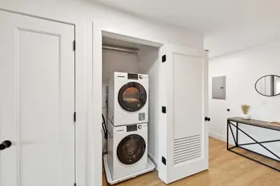 a washer and dryer in a white room at Market View Residence in Wilmington