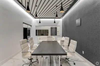 a dining room with a table and white chairs at Market View Residence in Wilmington