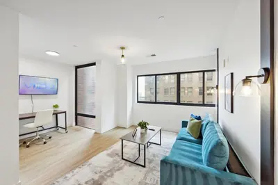 a living room with a blue couch and a table at Market View Residence 601 I 1 Bedroom 1 Bathroom in Wilmington