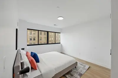 a white bedroom with a bed and a window at Market View Residence 601 I 1 Bedroom 1 Bathroom in Wilmington