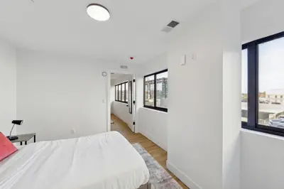 a white bedroom with a bed and windows at Stunning 1bd1bth I New Construction in Wilmington