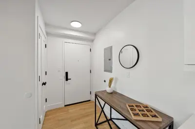a white room with a table and a mirror at Stunning 1bd1bth I New Construction in Wilmington