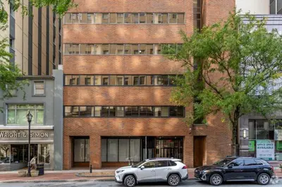 two cars parked in front of a brick building at Stunning 1bd1bth I New Construction in Wilmington