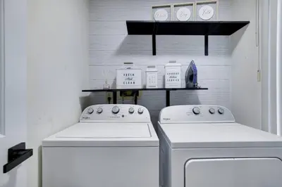 a kitchen with two white appliances and a shelf at The Hawley Nook at Lake Wallenpaupack in Hawley