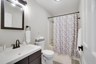 a bathroom with a toilet and a sink and a shower at The Hawley Nook at Lake Wallenpaupack in Hawley