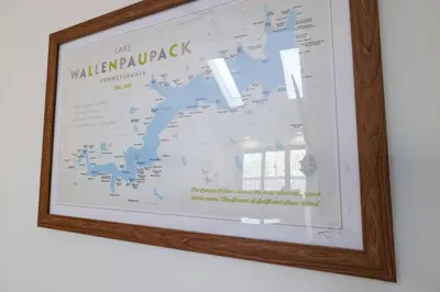 a framed map on a wall in a wooden frame at The Hawley Nook at Lake Wallenpaupack in Hawley