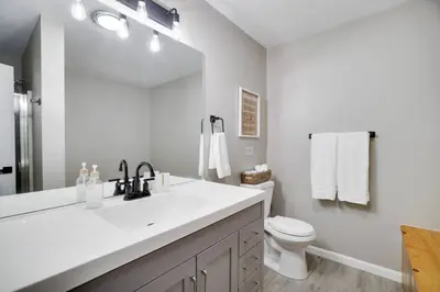 a white bathroom with a sink and a toilet at The Hawley Nook at Lake Wallenpaupack in Hawley